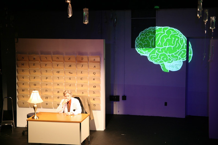 Paul Clay's Set Design, Lighting Design, and Video Design, for the production entitled Not God, Doctor's Office.