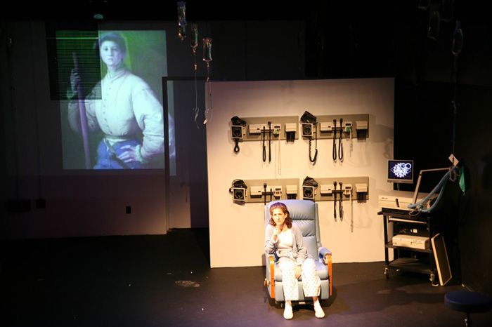 Paul Clay's Set Design, Lighting Design, and Video Design, for the production entitled Not God, Chemotherapy Station.