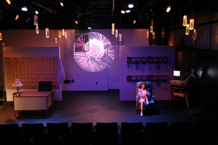 Paul Clay's Set Design, Lighting Design, and Video Design, for the production entitled Not God, Cancer Cell projection.