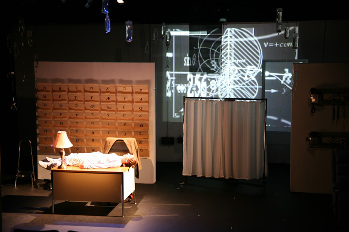 Paul Clay's Set Design, Lighting Design, and Video Design, for the production entitled Not God, Math formula projections.