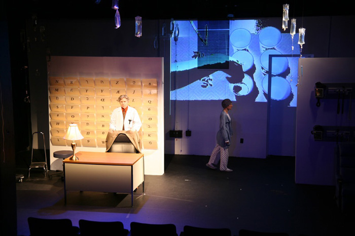 Paul Clay's Set Design, Lighting Design, and Video Design, for the production entitled Not God, Pills Distribution.