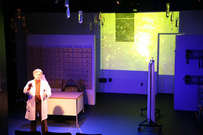Paul Clay's Set Design, Lighting Design, and Video Design, for the production entitled Not God, Doctor monologue.