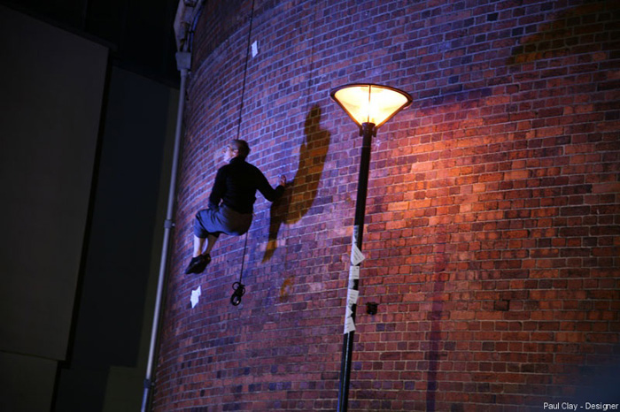 Paul Clay's Set Design, Lighting Design, and Video Design, for National Theatre Wales, Volcano Theatre, Welsh National Opera's co-production entitled Shelf Life at the Old Swansea Library, Wales, UK - aerial dance, exterior wall.
